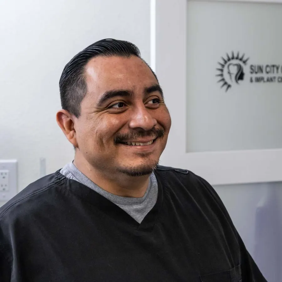 A male dental staff member inside the dental lab