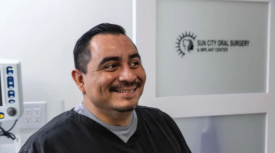 A male dental staff member inside the dental lab